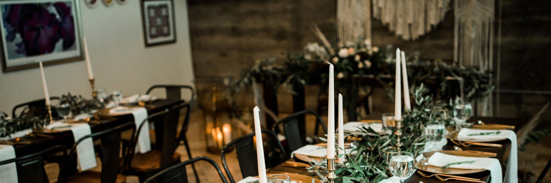 foliage garland lining a table with taper candles