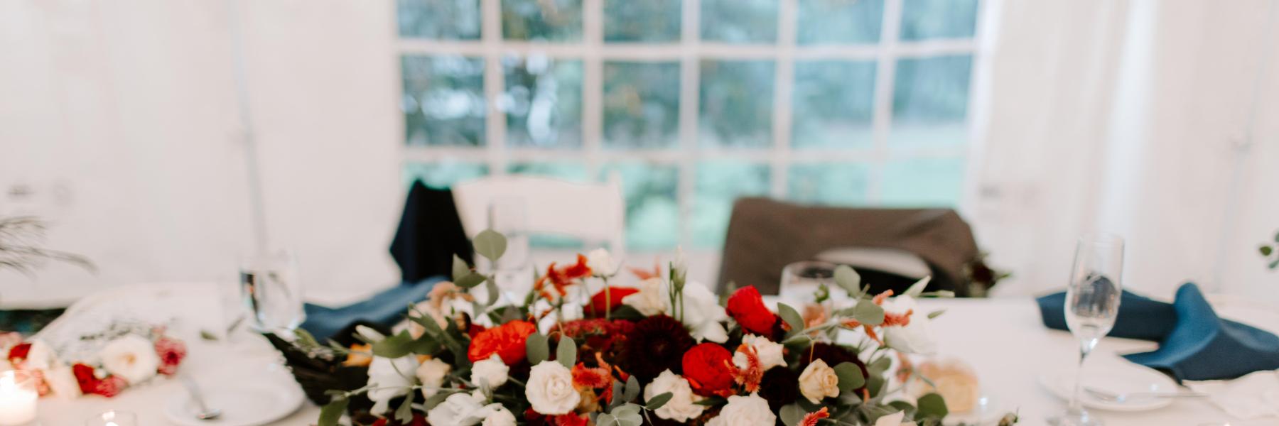 low wide floral arrangement on sweetheart table