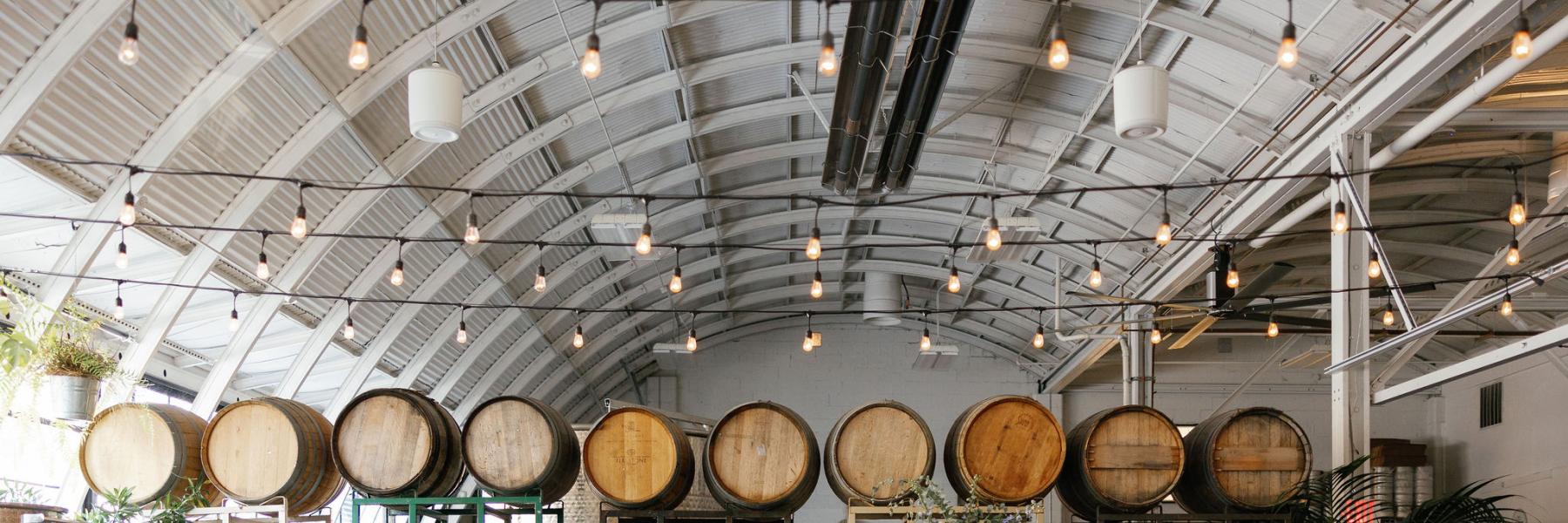 ceremony flower decor against wine barrels at Cooper's Hall