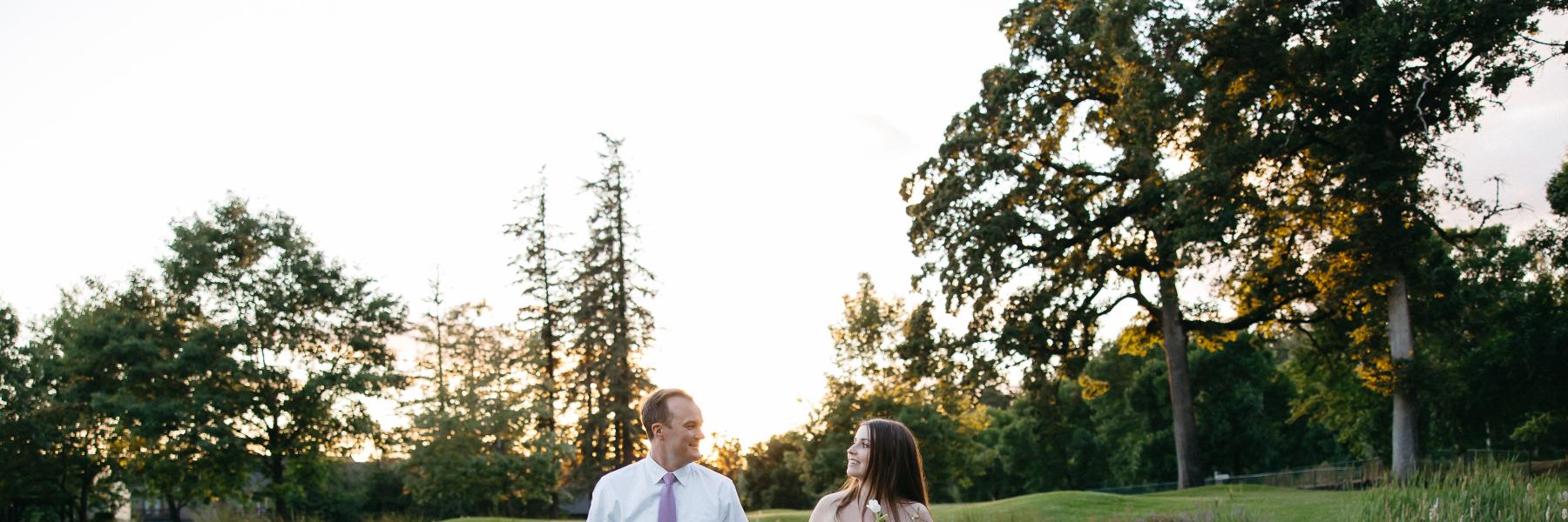 bride and groom walking the green