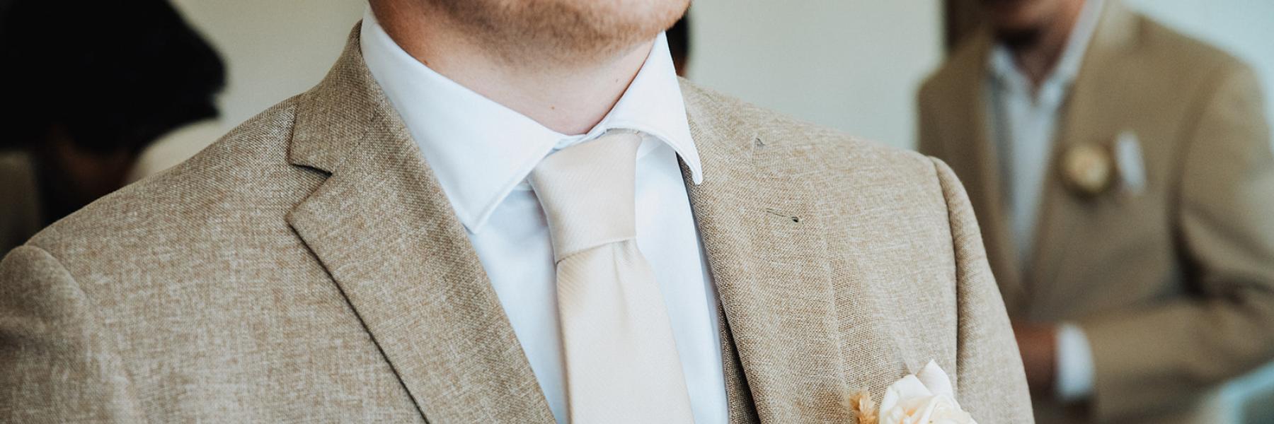pinning a boutonniere on a jacket