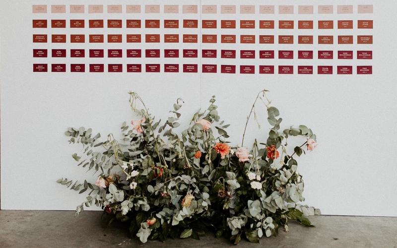 a large floral arrangement at the base of a seating chart