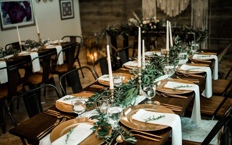 foliage garland lining a table with taper candles