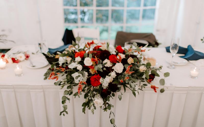 low wide floral arrangement on sweetheart table