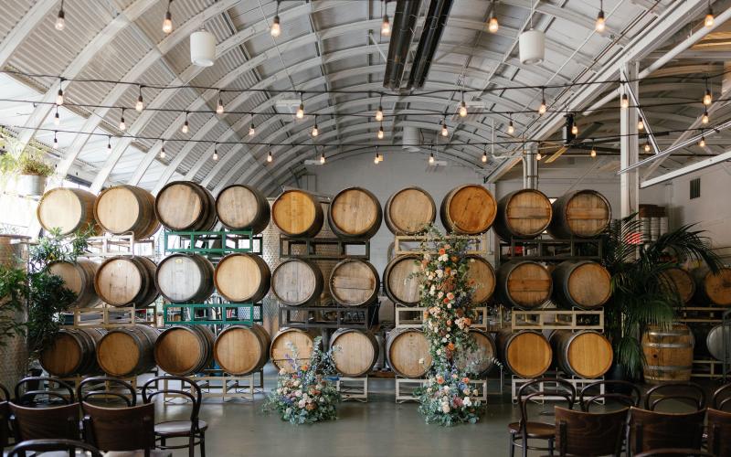 ceremony flower decor against wine barrels at Cooper's Hall