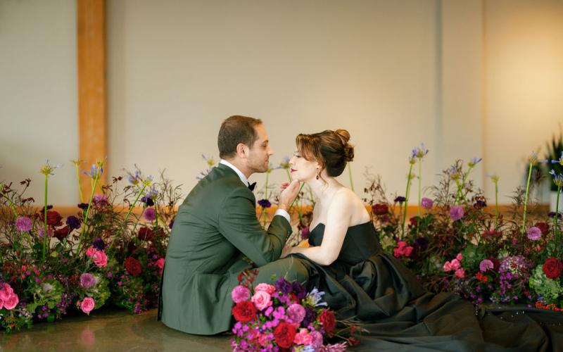 upgrowing floral pieces surround a bride and groom