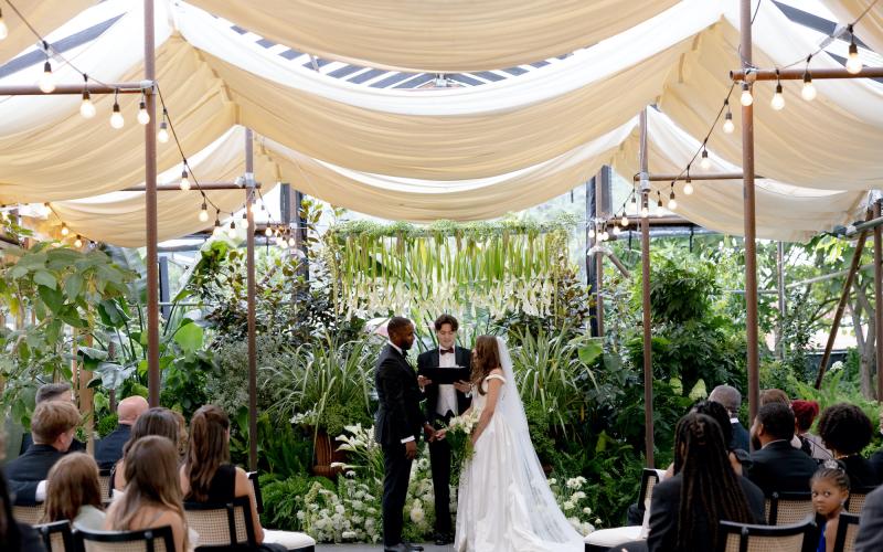 Victoria and Jon saying I Do under a suspended calla lily design
