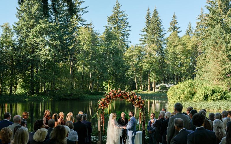 couple exchanging vows in front of a lake