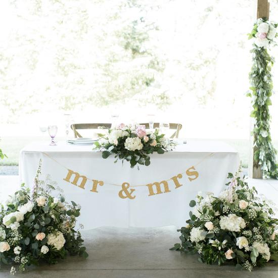 low and wide with large arrangements from ceremony