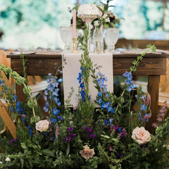 Large upgrowing arrangement capping farm table ends