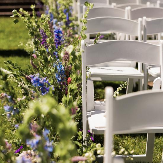 Large arrangements lining the aisle close up