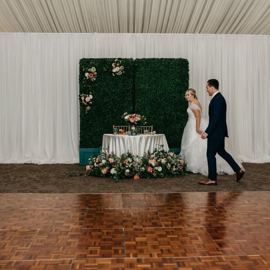 sweetheart table with flowers behind and in front