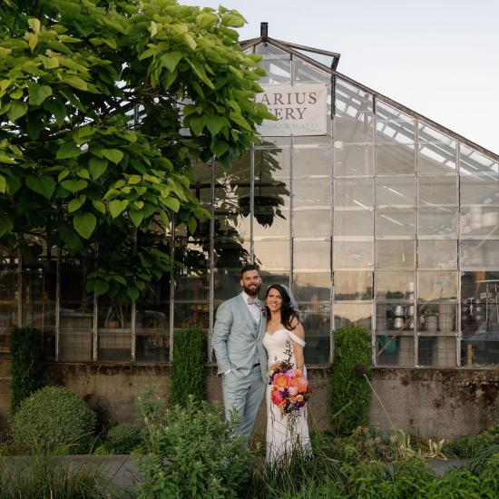 bride and groom in front of nursery