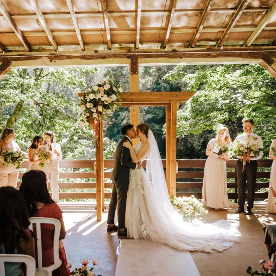 wedding ceremony with arbor in the background