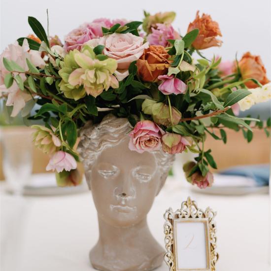 head statue vase with flowers