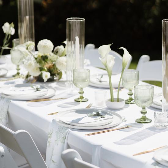 Table layout of pin cups, floral clusters, and candles